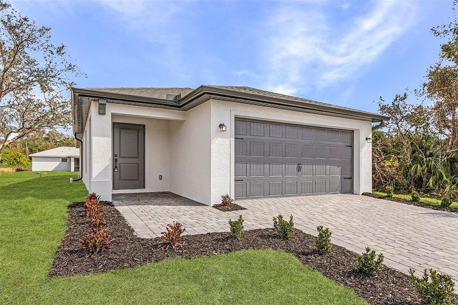 Front exterior of a new home in , North Port, FL, highlighting curb appeal (Image 2). Front exterior of a new home in , North Port, FL, highlighting curb appeal (Image 2).