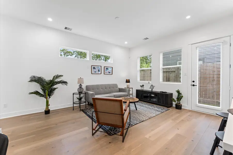 This inviting home features a spacious open-concept layout on the first floor, seamlessly connecting the living, dining, and kitchen areas to create a warm and functional gathering space. Large windows and glass door direct access to the backyard flooding the interior with natural light and extending the living space outdoors, perfect for entertaining or relaxing in the fresh air. The thoughtful design balances comfort and flow, making everyday living feel effortlessly connected to nature.