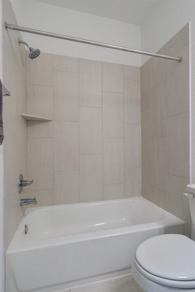 Full bathroom featuring toilet and shower / bath combination