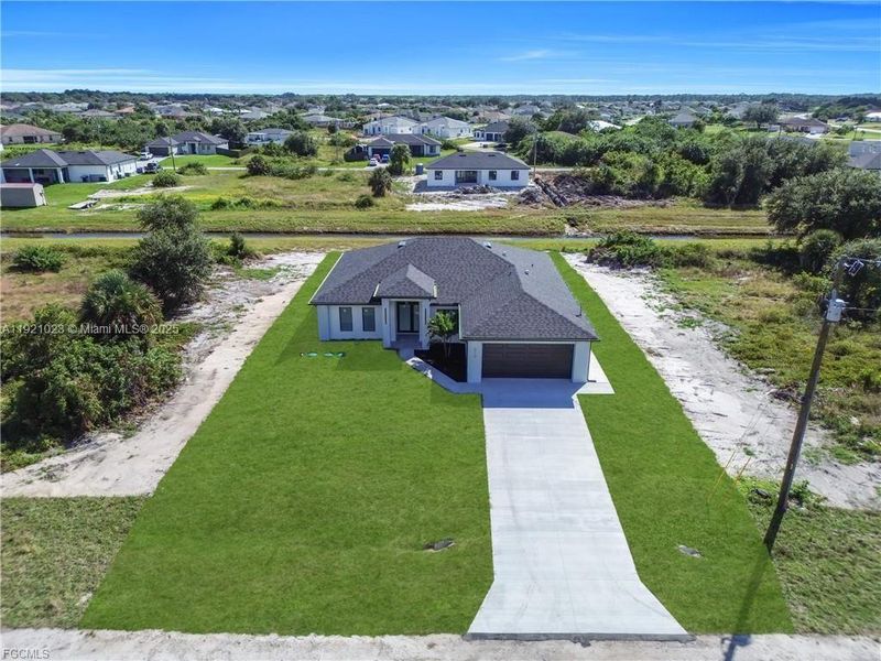 Front exterior of a new home in , Lehigh Acres, FL, highlighting curb appeal (Image 24). Front exterior of a new home in , Lehigh Acres, FL, highlighting curb appeal (Image 24).