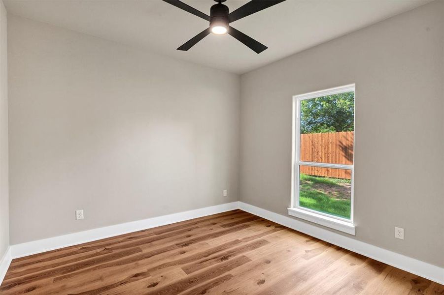 Spare room with light wood-style floors and ceiling fan Spare room with light wood-style floors and ceiling fan