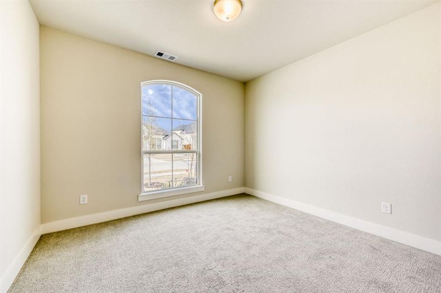 Carpeted spare room with baseboards