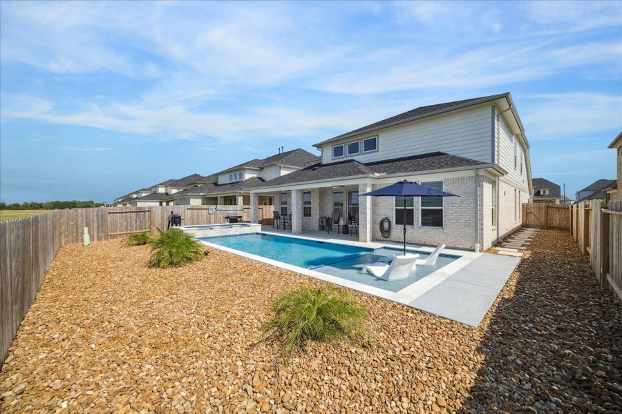 Serene backyard with a stylish heated saltwater pool, seating area, and privacy fencing. Bright, open, and perfect for enjoying outdoor leisure and entertaining guests. Serene backyard with a stylish heated saltwater pool, seating area, and privacy fencing. Bright, open, and perfect for enjoying outdoor leisure and entertaining guests.