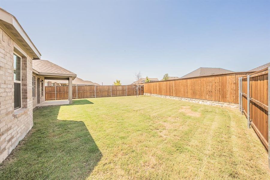 Fenced backyard featuring a patio Fenced backyard featuring a patio