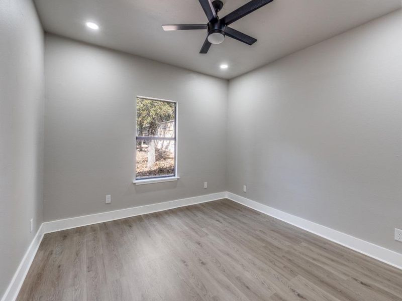 Empty room with light wood finished floors, recessed lighting, and a ceiling fan