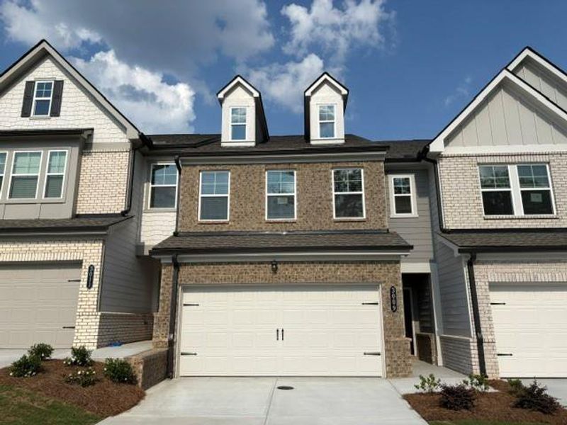 Front exterior of a new home in Towns at Ivy Creek, Buford, GA, highlighting curb appeal (Image 2). Front exterior of a new home in Towns at Ivy Creek, Buford, GA, highlighting curb appeal (Image 2).