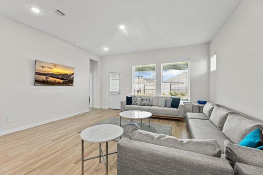 The living room is spacious with a wonderful view of the yard. This is also where you access the primary bedroom and back yard. The living room is spacious with a wonderful view of the yard. This is also where you access the primary bedroom and back yard.