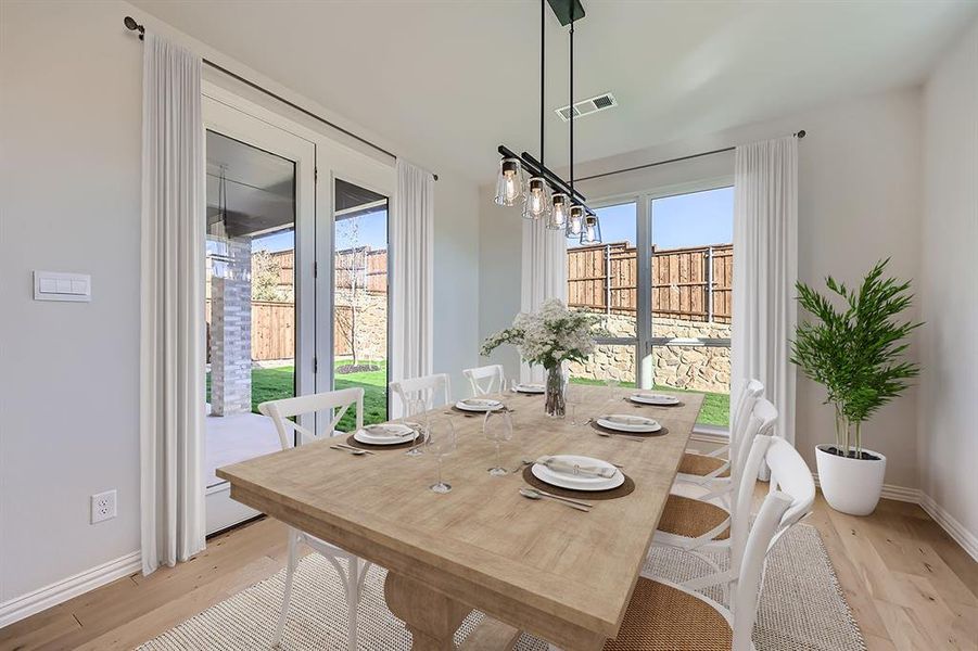 VIRTUALLY STAGED PHOTO - Dining space with light wood-type flooring