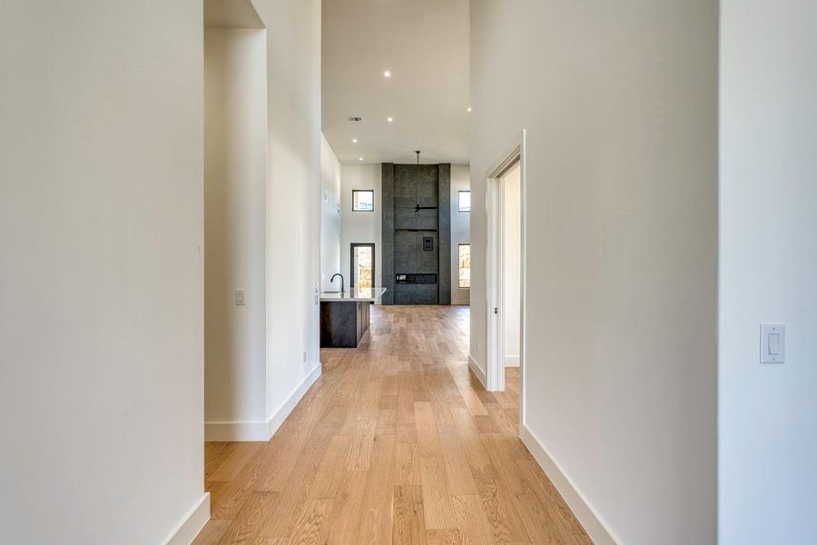 Clean lines and warm hardwood floors guide the eye toward a soaring double-height living area. Clean lines and warm hardwood floors guide the eye toward a soaring double-height living area.