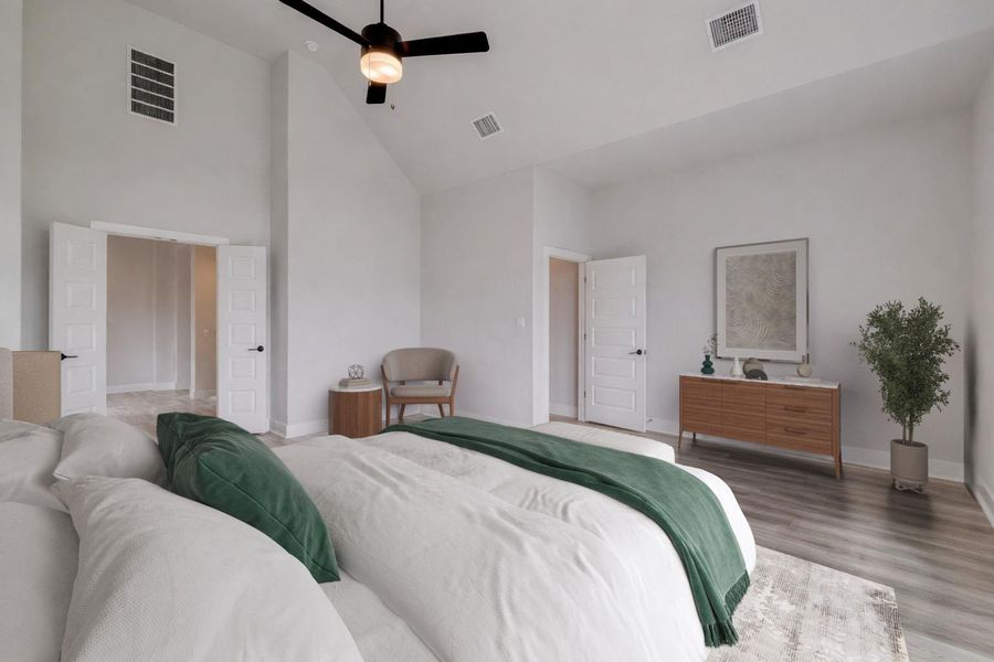 Vaulted ceilings with a ceiling fan, recessed lighting, double-door entry, wood-finish flooring, and crisp white walls
