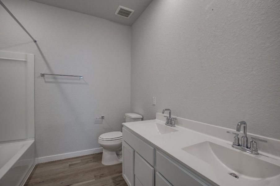 A bathroom with a toilet sink and a bathtub.