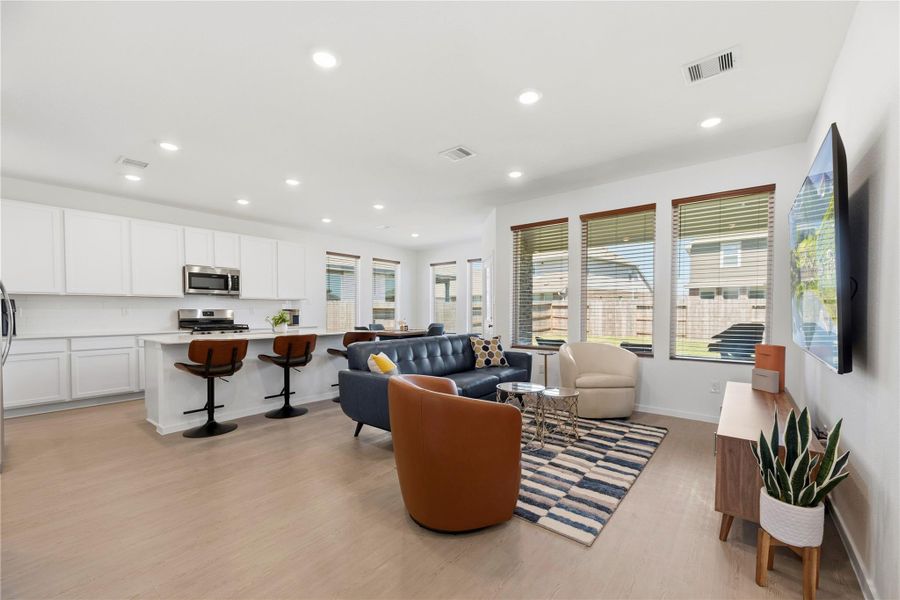 Spacious living room flowing seamlessly into kitchen and dining.