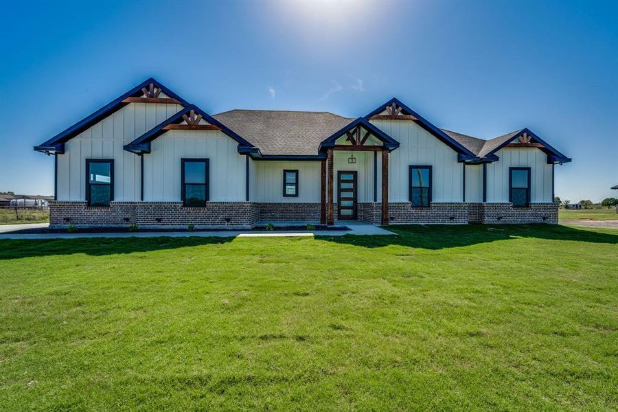 Modern farmhouse style home with a front lawn