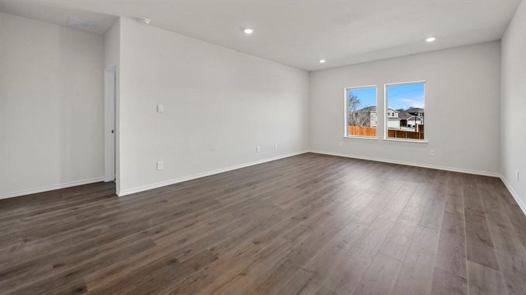 Spare room featuring dark wood-style floors and recessed lighting