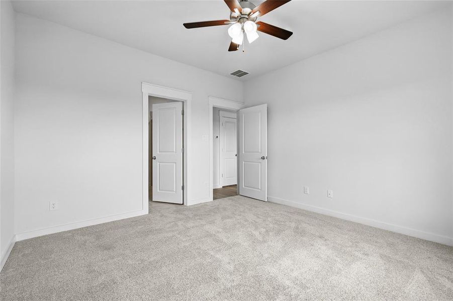 Unfurnished bedroom with carpet, baseboards, and ceiling fan Unfurnished bedroom with carpet, baseboards, and ceiling fan
