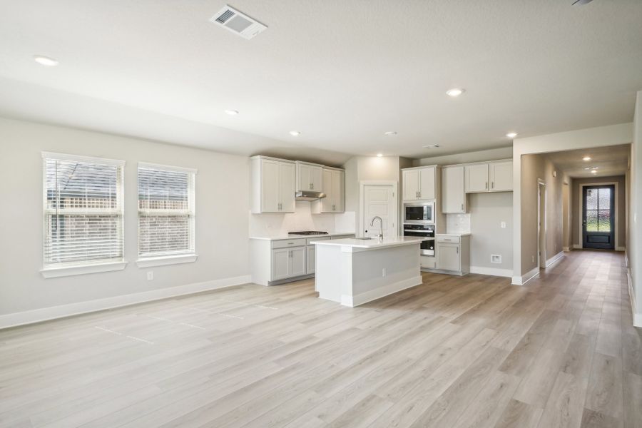 Dining room and kitchen in the Preston floorplan at a Meritage Homes community.