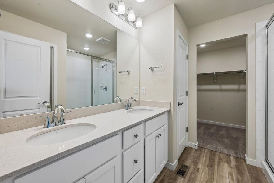 A bathroom with a large mirror.