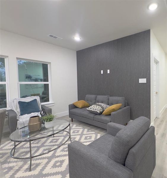 Living room with light hardwood / wood-style floors