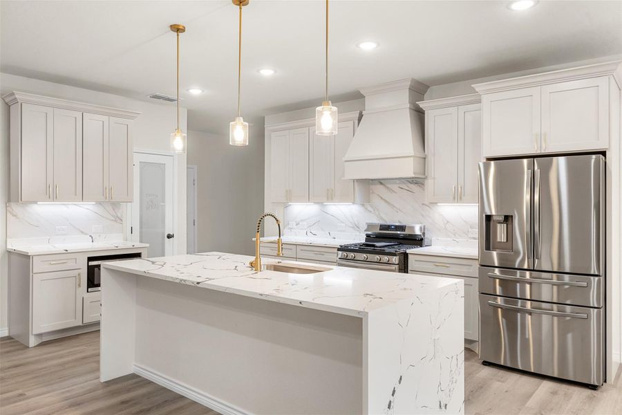 Culinary dreams come alive in this kitchen, featuring an oversized island, gas range, and premium finishes. Culinary dreams come alive in this kitchen, featuring an oversized island, gas range, and premium finishes.