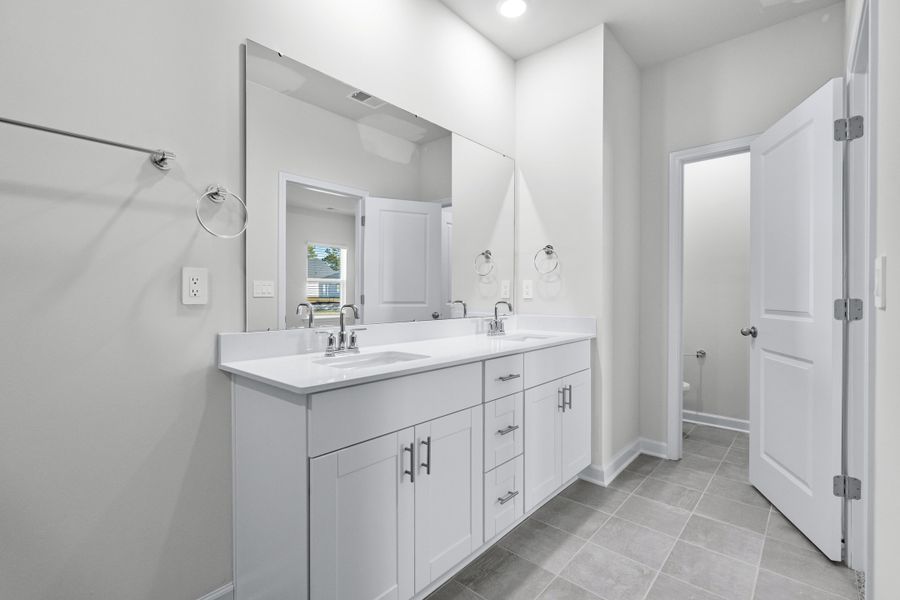 The primary ensuite boasts duel sinks, tile shower and large walk-in closet.