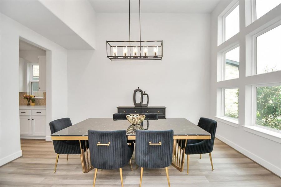 A large formal dining area with a beautiful chandelier.