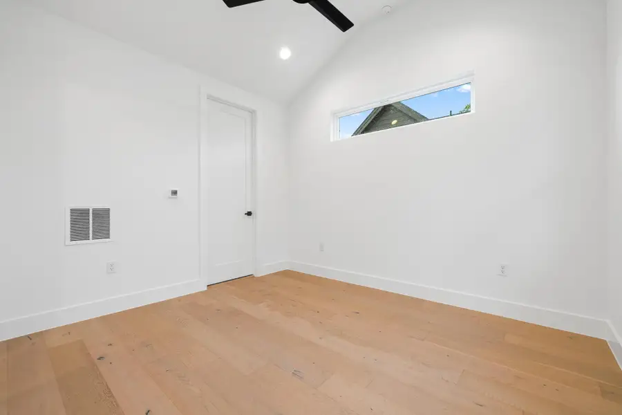 Spare room with a ceiling fan, light wood finished floors, vaulted ceiling, and recessed lighting Spare room with a ceiling fan, light wood finished floors, vaulted ceiling, and recessed lighting