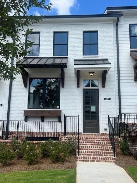 Front exterior of a new home in Palisades Townhomes, Cumming, GA, highlighting curb appeal (Image 15).