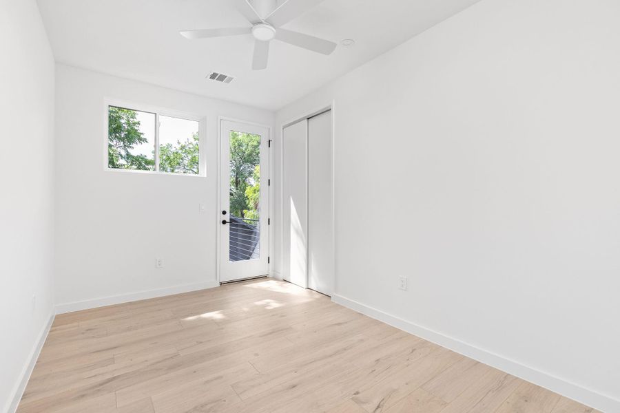 Empty room with light wood-style floors and ceiling fan Empty room with light wood-style floors and ceiling fan