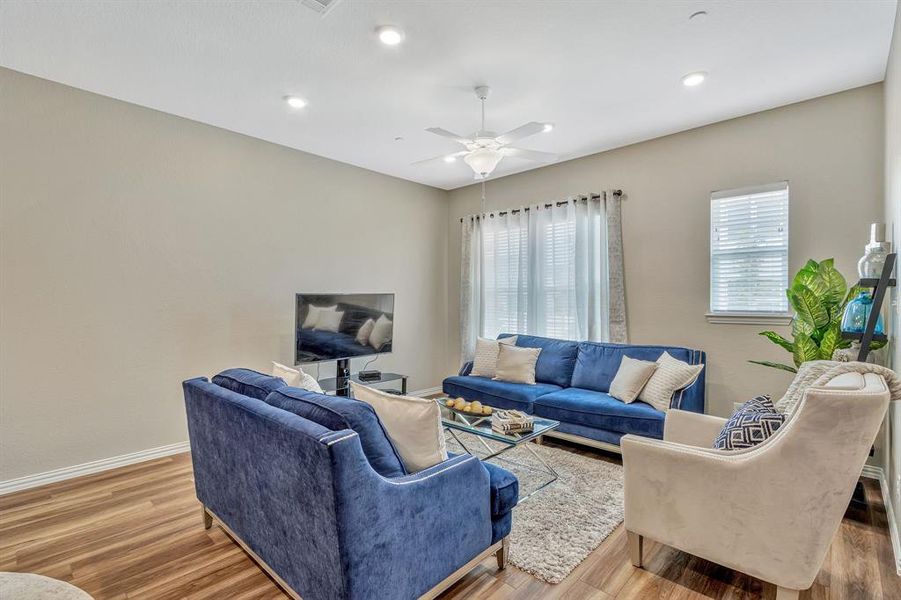 Living room featuring hardwood / wood-style floors and ceiling fan