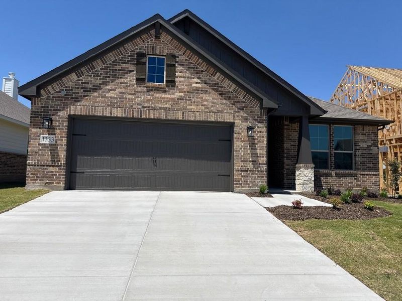 Front exterior of a new home in Covenant Park, Springtown, TX, highlighting curb appeal (Image 1). Front exterior of a new home in Covenant Park, Springtown, TX, highlighting curb appeal (Image 1).