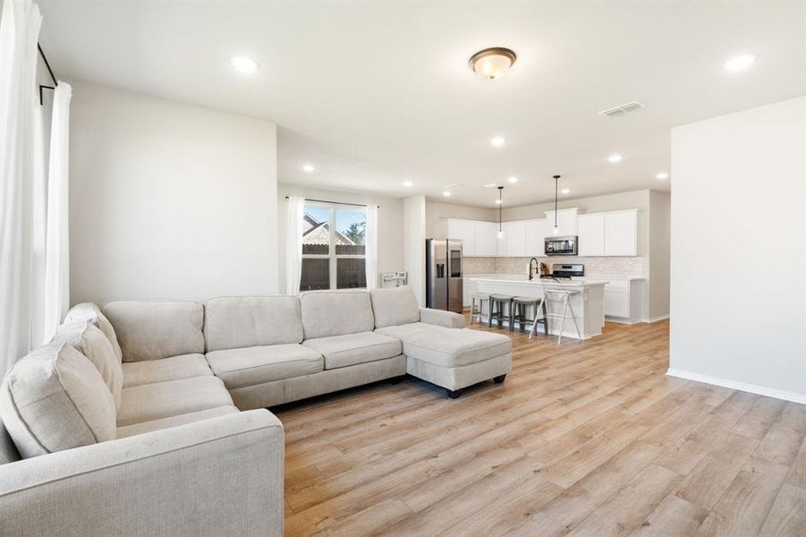 Living room featuring recessed lighting and light wood-type flooring Living room featuring recessed lighting and light wood-type flooring