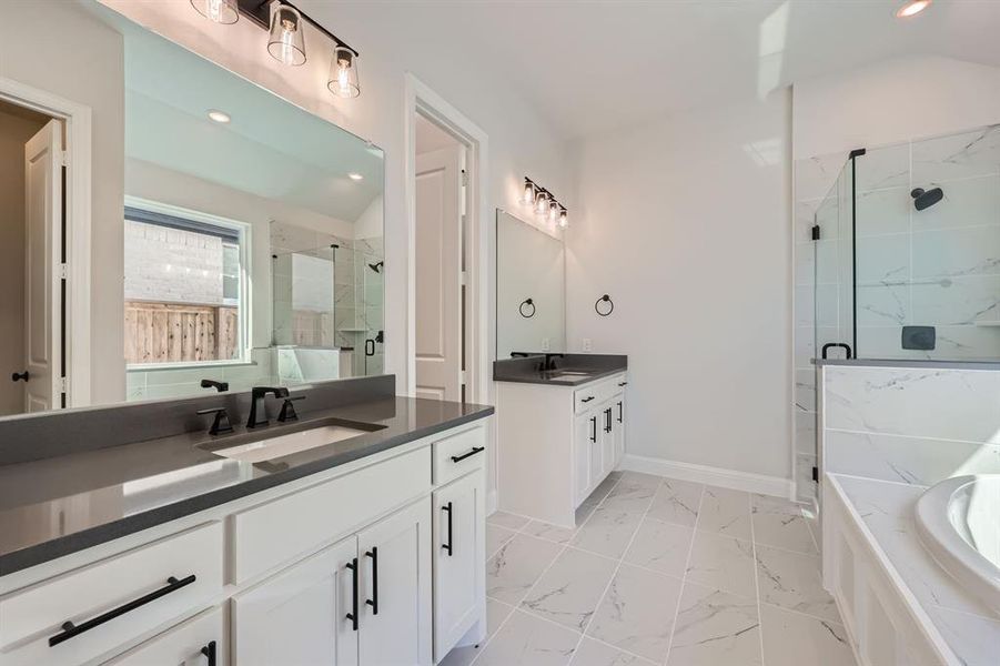 Bathroom with vanity, separate shower and tub, and vaulted ceiling