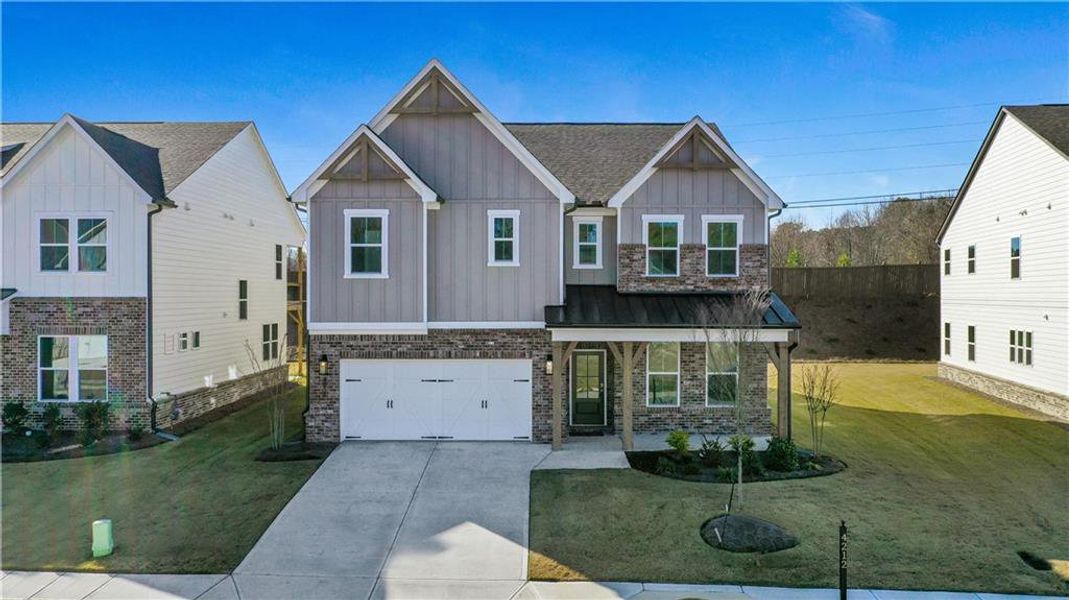 Front exterior of a new home in The Paddocks at Doc Hughes, Buford, GA, highlighting curb appeal (Image 22). Front exterior of a new home in The Paddocks at Doc Hughes, Buford, GA, highlighting curb appeal (Image 22).