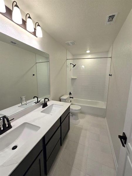 Secondary full bathroom with dual vanities