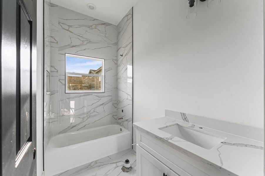 Stylish second bathroom with modern finishes Photos are representative of the same floor plan built by this builder. Finishes will be the same or similar