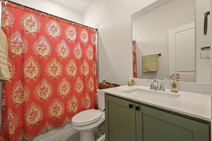 Bathroom featuring vanity and a shower with shower curtain Bathroom featuring vanity and a shower with shower curtain