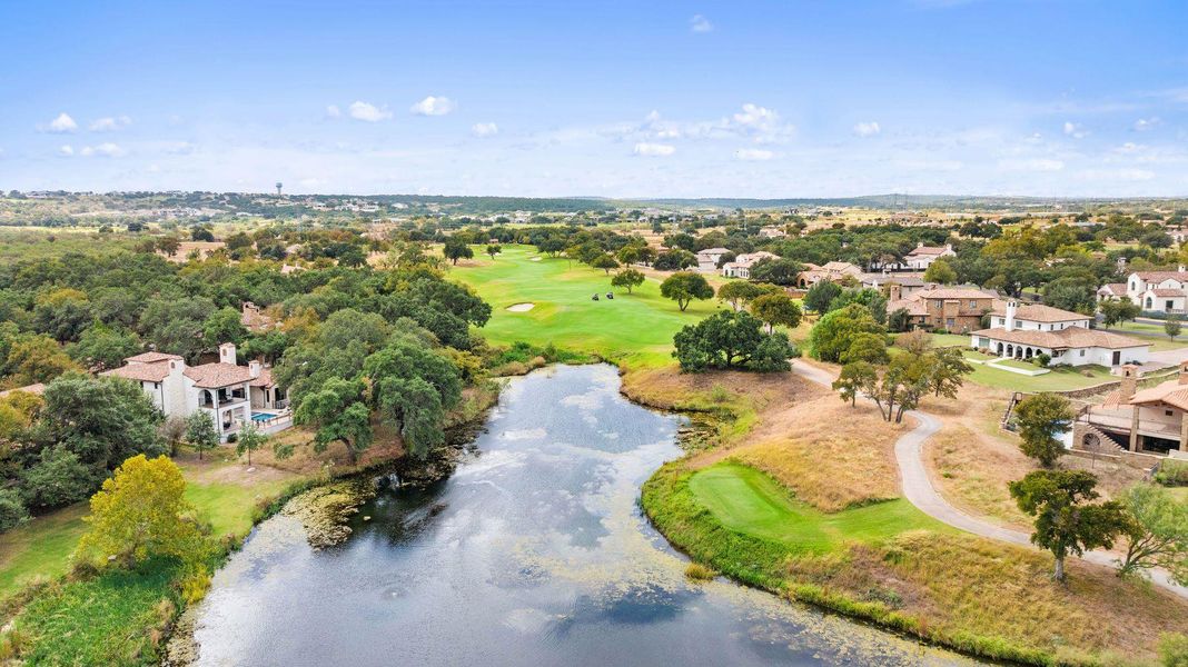 Aerial view of residential area with a large body of water and a golf course