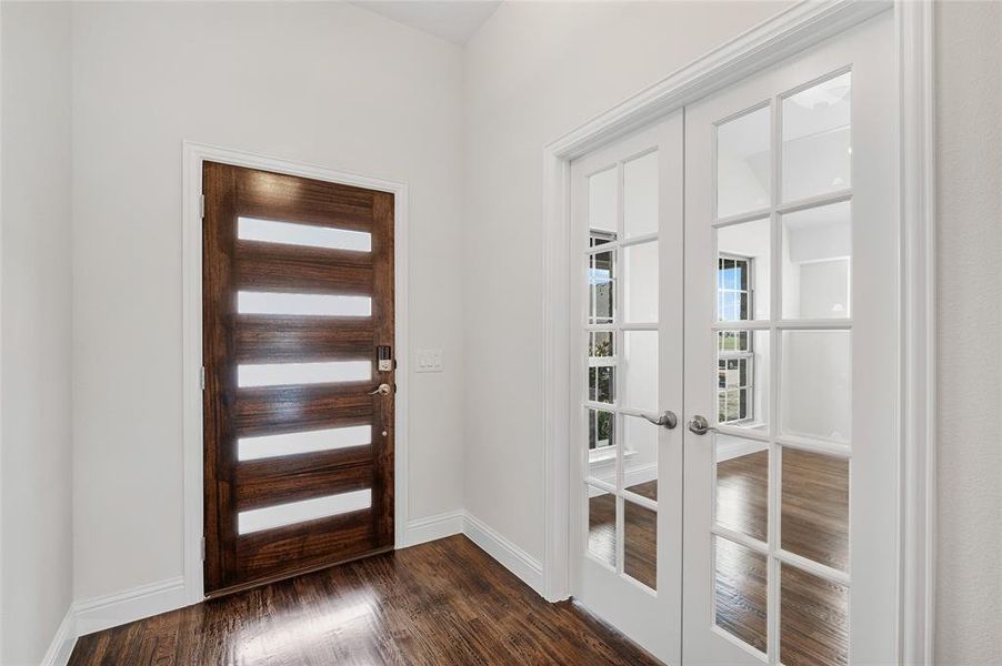 Foyer entrance featuring french doors and dark wood finished floors Foyer entrance featuring french doors and dark wood finished floors