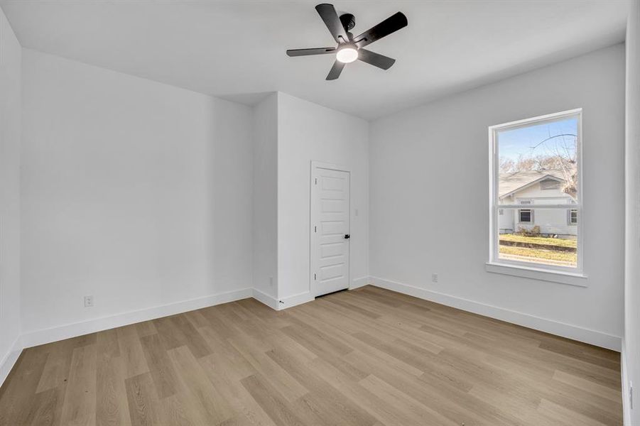 Spare room featuring light hardwood / wood-style flooring, plenty of natural light, and ceiling fan