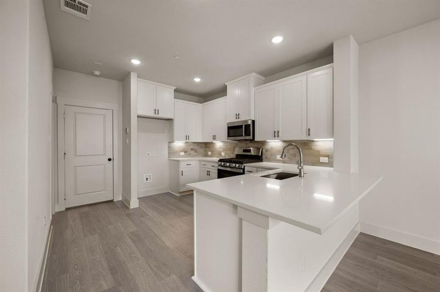 The oversized kitchen peninsula offers the perfect place for a quick meal.