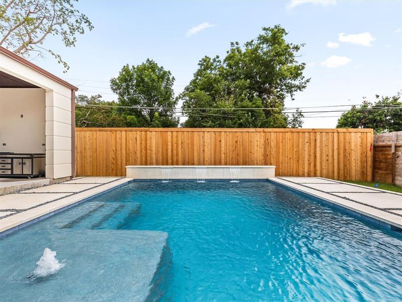 View of swimming pool with pool water feature