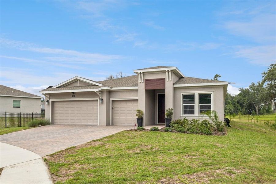 Front exterior of a new home in Providence, Davenport, FL, highlighting curb appeal (Image 25). Front exterior of a new home in Providence, Davenport, FL, highlighting curb appeal (Image 25).