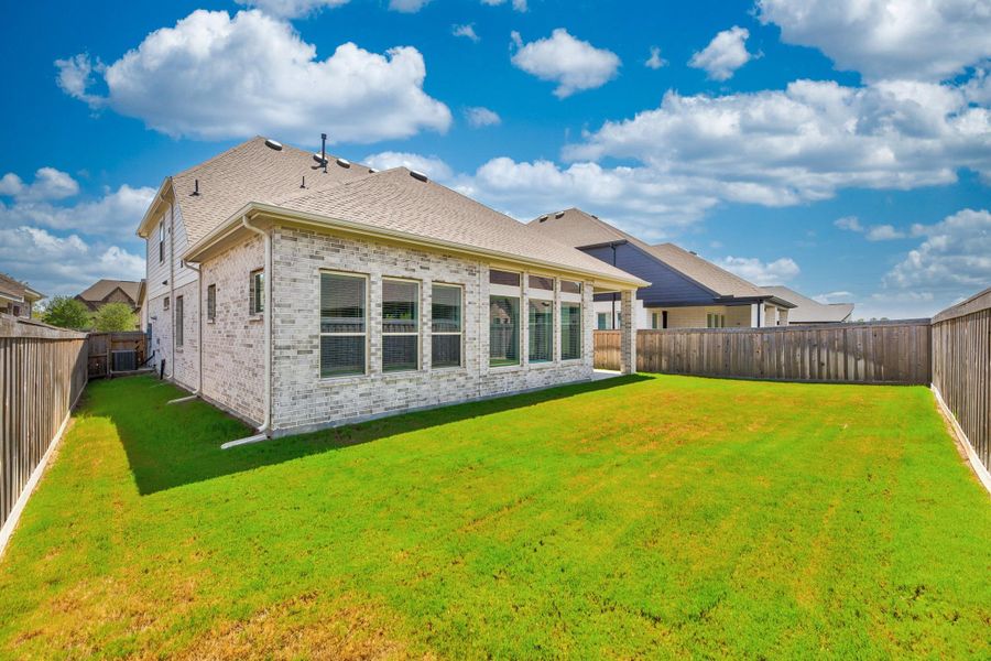 Exterior details and patio area of a home in Dunham Pointe - Enclave Collection, Cypress (Image 27).