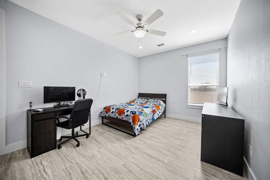 Bedroom featuring a desk, light wood-style floors, ceiling fan, and recessed lighting