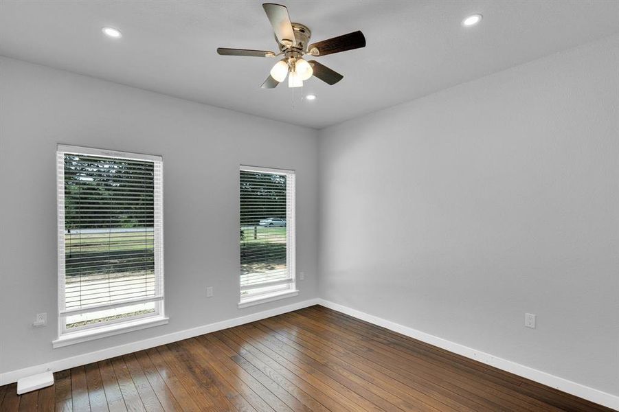 Bedroom with baseboards, plenty of natural light, a ceiling fan, and recessed lighting