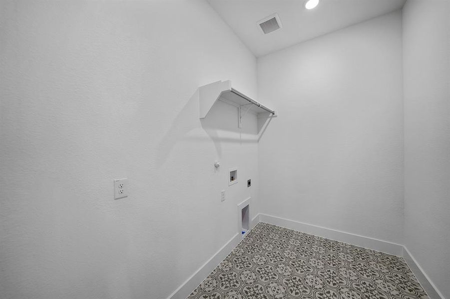 Washroom featuring gas dryer hookup, hookup for an electric dryer, washer hookup, and recessed lighting Washroom featuring gas dryer hookup, hookup for an electric dryer, washer hookup, and recessed lighting