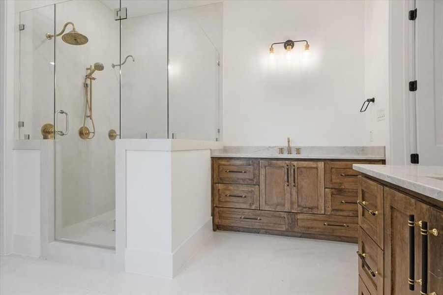 Bathroom featuring a shower with door and vanity