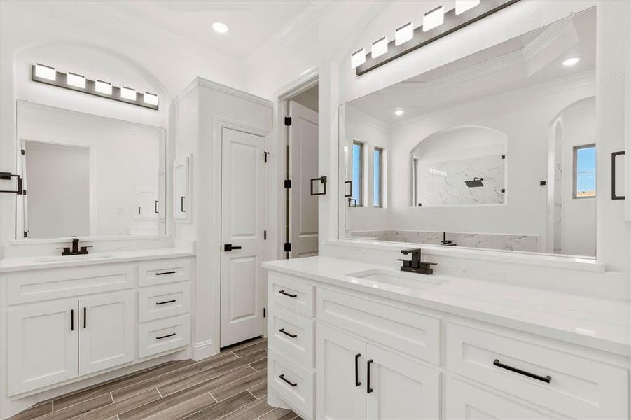 Master bath  featuring a shower, double vanity, and crown molding