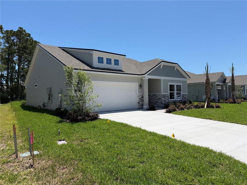 Front exterior of a new home in Reserve East, Flagler Beach, FL, highlighting curb appeal (Image 25).