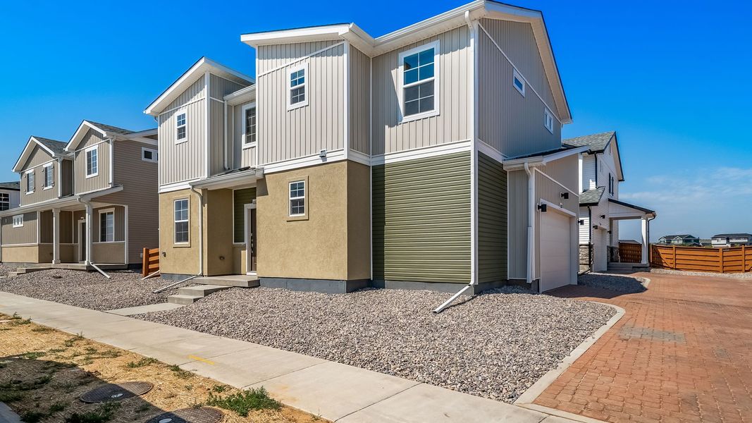 Front exterior of a new home in Reunion, Commerce City, CO, highlighting curb appeal (Image 2). Front exterior of a new home in Reunion, Commerce City, CO, highlighting curb appeal (Image 2).